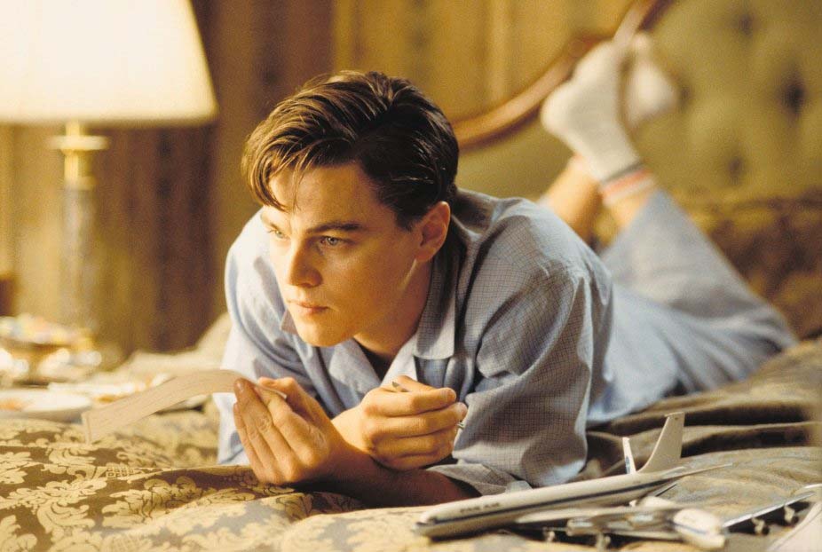 Actor Leonardo DiCaprio on bed with Pan Am model airplanes